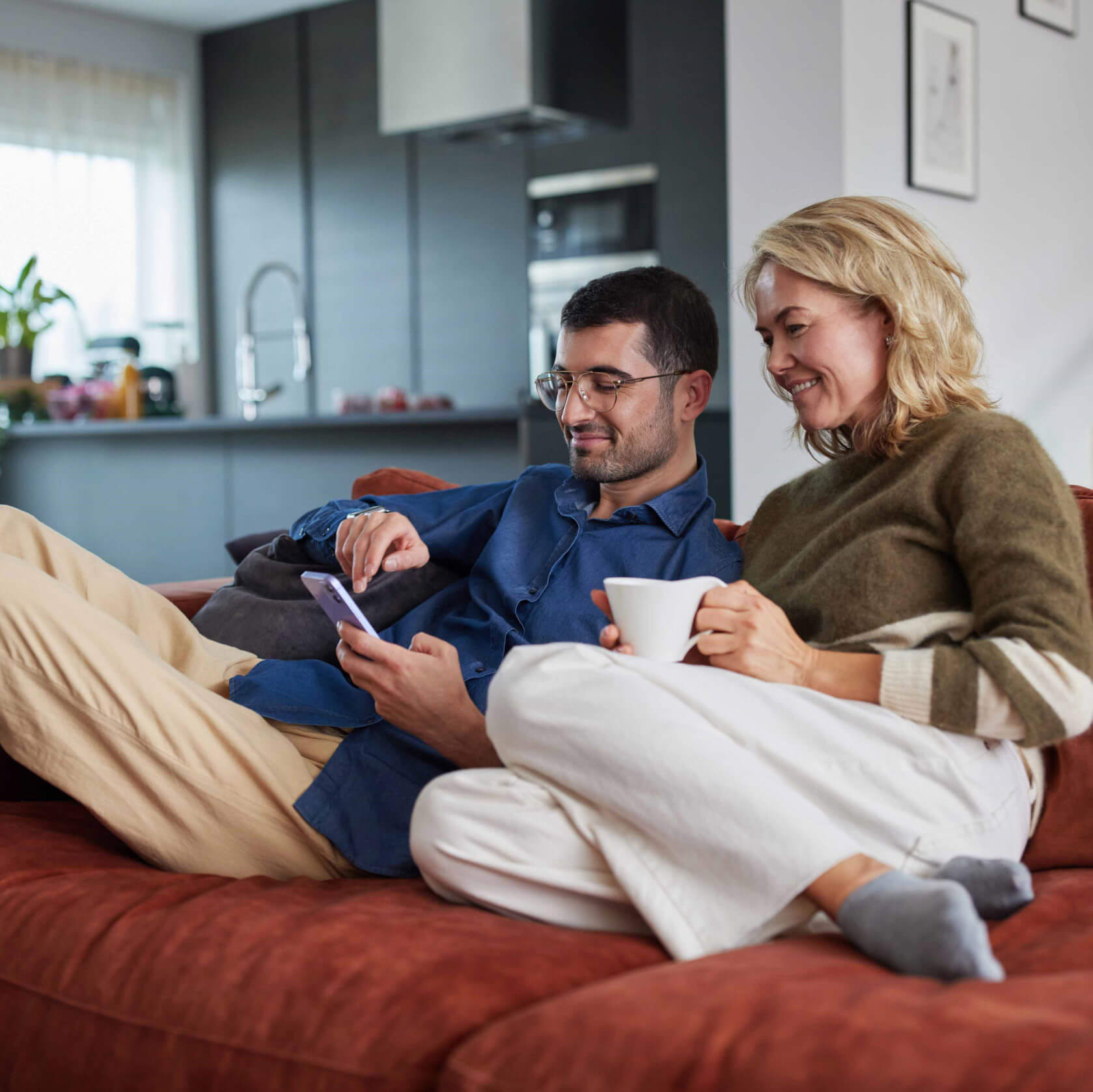 A smiling couple browsing services on a mobile device